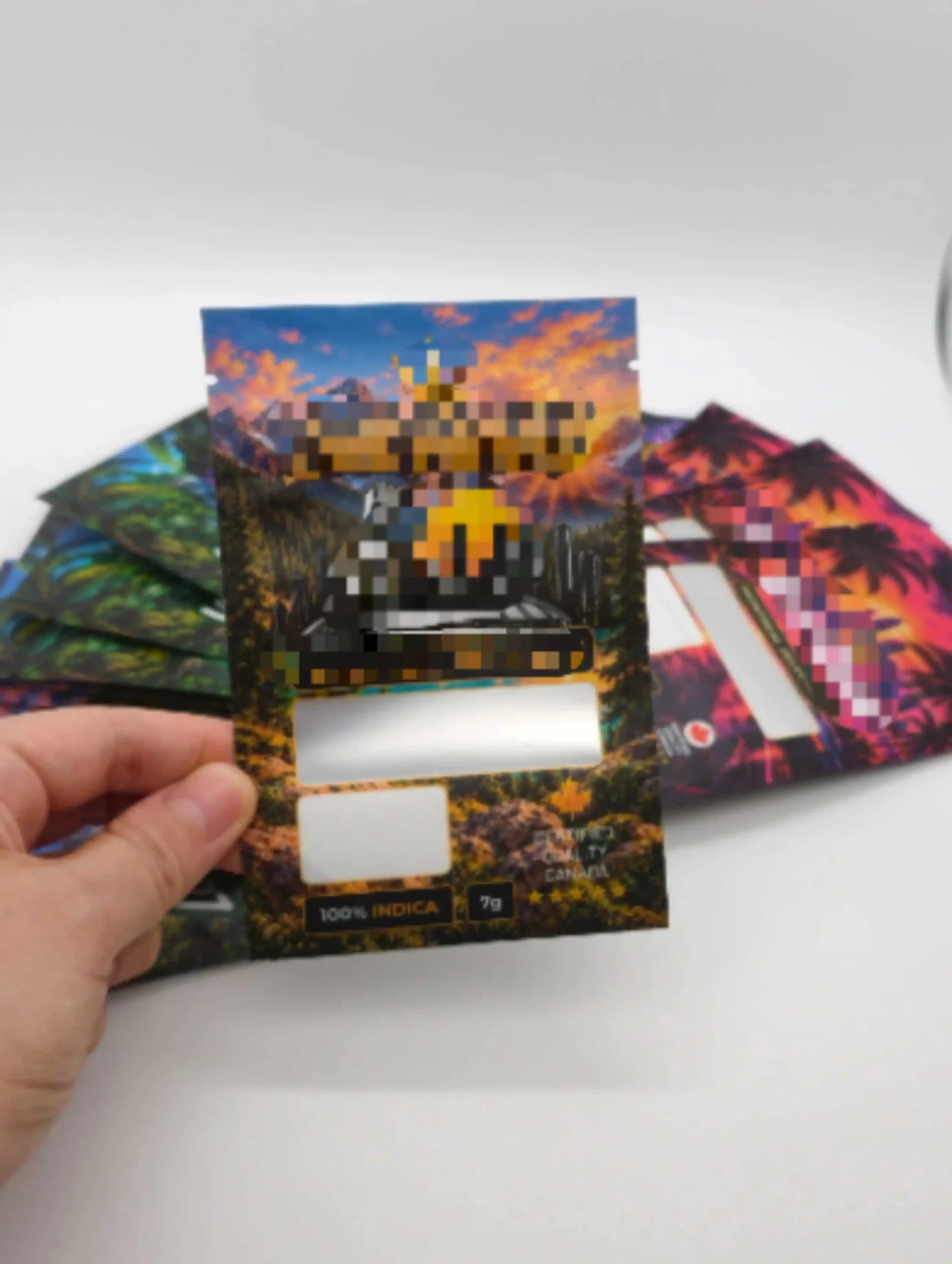 Anonymized printed pouch held in hand with front window areas visible